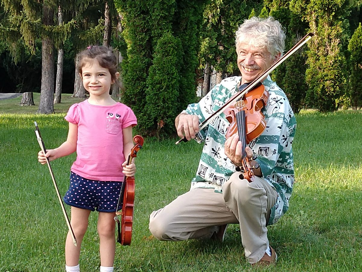 Young child violin student with Zebie outdoors, Ann Arbor children's music lessons