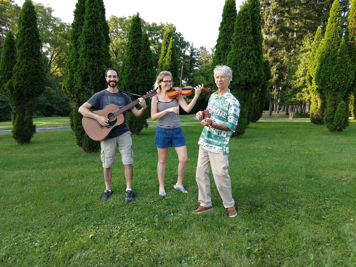 Zebie with two students — guitar and violin — in Ann Arbor