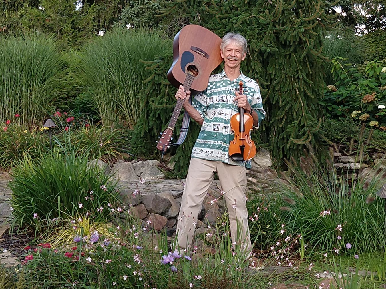 Zebie in his garden with guitar and violin, Ann Arbor music teacher